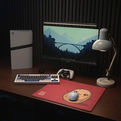 russet potato desk setup with keyboard monitor and mouse pad