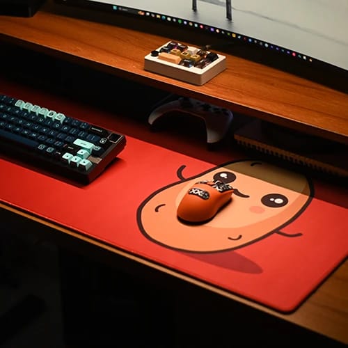 russet potato gaming desk setup with red character desk mat